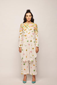 fleur round hem tunic co-ord set,
floral embroidered co-ord set for women,
pastel beige co-ord set,
linen co-ord set with floral embroidery,
summer co-ord set for women,
co-ord set with round hem tunic,
elegant co-ord set for girls,
lightweight tunic co-ord set,
embroidered tunic and trouser set,
co-ord set with pearl and sequin details,
custom size co-ord set,
designer co-ord set for women,
handmade floral co-ord set,
off-white linen co-ord set,
floral jacquard co-ord set,
co-ord set with re