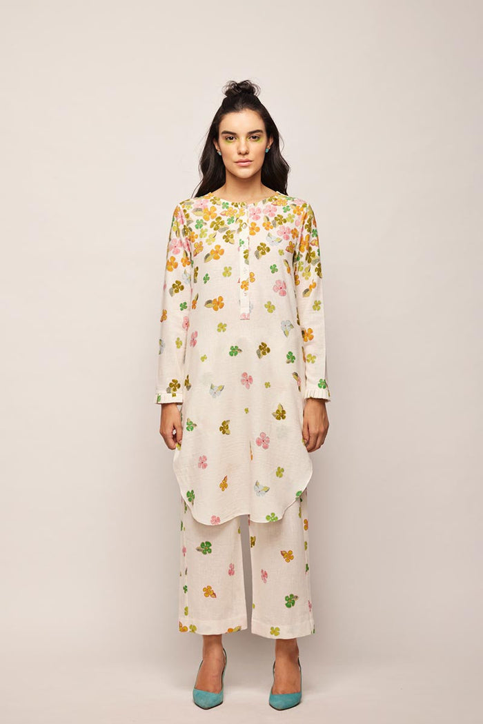 fleur round hem tunic co-ord set,
floral embroidered co-ord set for women,
pastel beige co-ord set,
linen co-ord set with floral embroidery,
summer co-ord set for women,
co-ord set with round hem tunic,
elegant co-ord set for girls,
lightweight tunic co-ord set,
embroidered tunic and trouser set,
co-ord set with pearl and sequin details,
custom size co-ord set,
designer co-ord set for women,
handmade floral co-ord set,
off-white linen co-ord set,
floral jacquard co-ord set,
co-ord set with re