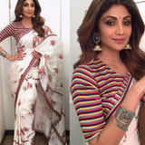 A collage of two images, the top one featuring Shilpa Shetty in a red and white striped crop top and the bottom one showcasing a printed saree with floral and elephant motifs in a white and multicolor scheme. Both images have a striped background.