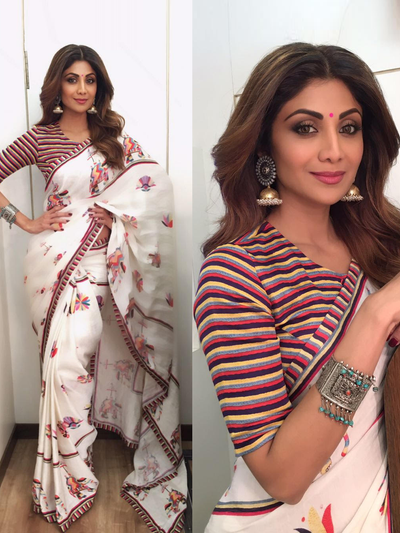 A collage of two images, the top one featuring Shilpa Shetty in a red and white striped crop top and the bottom one showcasing a printed saree with floral and elephant motifs in a white and multicolor scheme. Both images have a striped background.